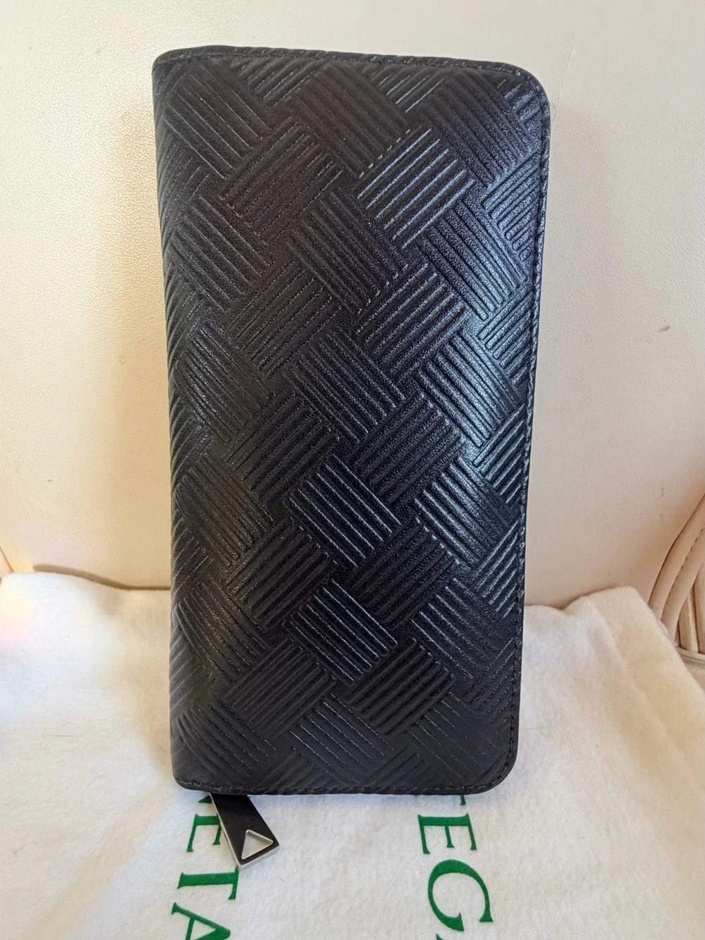 BOTTEGA VENETA Black Zip Around Wallet in Intrecciato Debossed Calfskin. UNISEX.